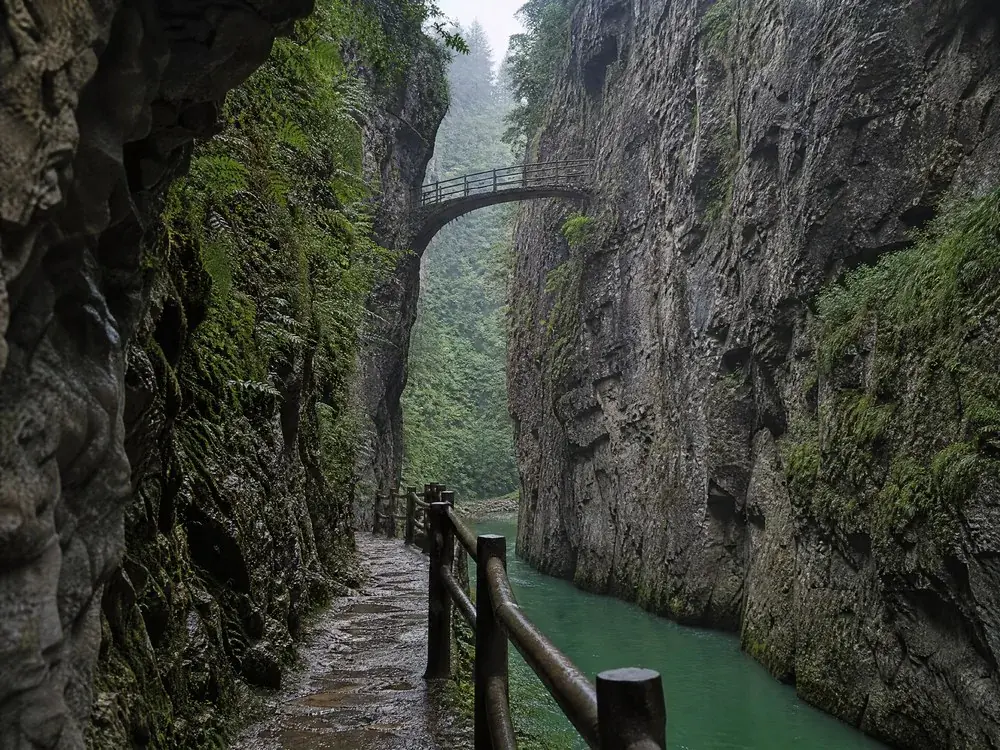 A small footbridge spanning the gorge high above the water
