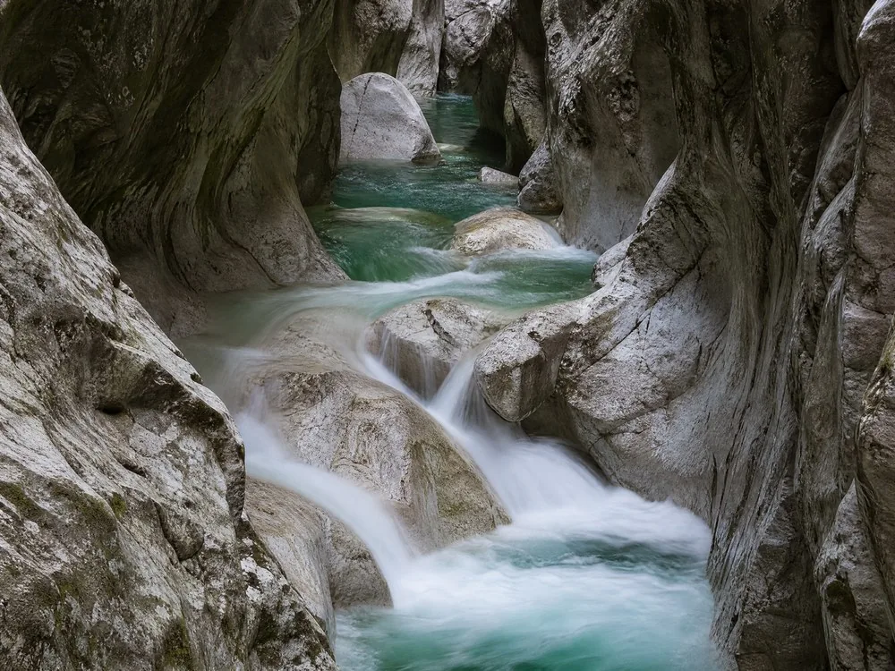 White water pouring over pale limestone boulders